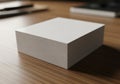 A stack of plain, white paper sheets sits neatly on a wooden desk surface Royalty Free Stock Photo