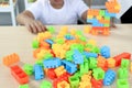 Stack of plastic colorful toy brick block toys for children on top of table, piece for bricks toy lego with kid hands, decorative