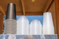 A stack of plastic cups on a metal shelf Royalty Free Stock Photo