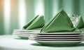 A stack of plates with green napkins on top Royalty Free Stock Photo
