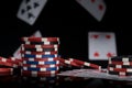 Stack of poker chips on the background of falling playing cards Royalty Free Stock Photo