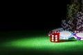 Stack of Poker chips on a green gaming poker table with poker dice at the casino . Playing a game with dice. Casino dice Concept Royalty Free Stock Photo