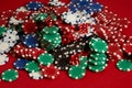 Stack of poker chips on red background at casino Royalty Free Stock Photo