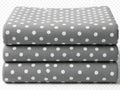 Stack of polka dot fabric sheets in gray and white Royalty Free Stock Photo