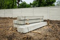 Stack of precast concrete wall panels on fresh ground floor,to build a wall on the construction site outside