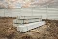 Stack of precast concrete wall panels on fresh ground floor,to build a wall on the construction site outside