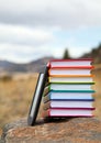 Stack of printed books with electronic book reader Royalty Free Stock Photo