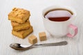 Stack of puff cookies with peanuts, cup of tea, sugar Royalty Free Stock Photo