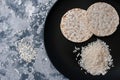 Stack of puffed rice bread slices on black plate from above Royalty Free Stock Photo