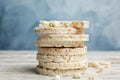 Stack of puffed rice cakes on white table against light blue background