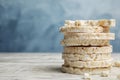 Stack of puffed rice cakes on wooden table against light blue background. Space for text Royalty Free Stock Photo