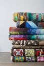 Stack of quilts on white wall background Royalty Free Stock Photo