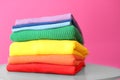 Stack of rainbow clothes on table