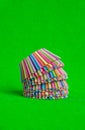 Stack Rainbow colored paper baking cups for muffins and cupcakes on a green background minimal creative concept. Space