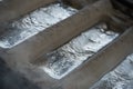 Stack of raw aluminum ingots in aluminum profiles factory