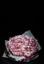 Stack of raw beef meat burger steak cutlets beefsteack on paper on dark wooden background Royalty Free Stock Photo