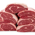Stack of raw beef ribeye steaks with marbling and fat cap isolated on white background Royalty Free Stock Photo