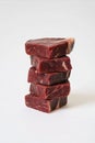 Stack of raw premium beef steaks on white background Royalty Free Stock Photo