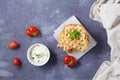 A stack of ready-to-eat zucchini waffles and basil on baking paper on the table. Vegetable dietary vegetarian food. Top view. Copy