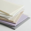 A stack of rectangular acrylic sheets in various pastel shades, including white, cream, Royalty Free Stock Photo