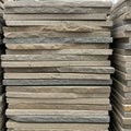 A stack of rectangular stone tiles, varying in shades of gray and beige. Each tile has a Royalty Free Stock Photo