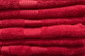 Textured red bath towels stacked close up. Royalty Free Stock Photo