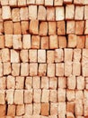 A stack of red bricks fills the frame used to for construction in India Royalty Free Stock Photo