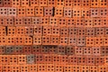 Stack of red bricks with holes