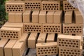 A stack of red bricks on a white background with a pointing trowel Royalty Free Stock Photo