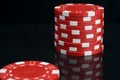 Stack of red casino chips on black background with reflection Royalty Free Stock Photo