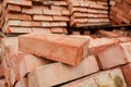 A stack of red clay bricks in rows close up. Royalty Free Stock Photo