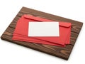 Stack of red envelopes with white card on wooden surface isolated on white background Royalty Free Stock Photo