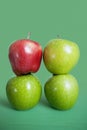 Stack of red and green apples over colored background Royalty Free Stock Photo