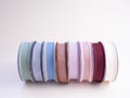 A stack of reels with multi-colored reps ribbons for decoration and packaging of gifts and bouquets