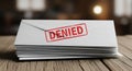 Stack of Rejected Envelopes with Bold Denied Stamp on Wooden Desk Royalty Free Stock Photo
