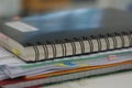 Stack of report and black notebook