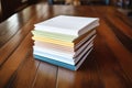 a stack of resumes on a wooden table