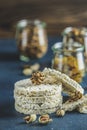 American puffed rice cakes. Healthy snacks with almonds, raisins, peanuts, pistachios in glass jars on classic blue concrete Royalty Free Stock Photo