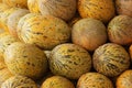 Stack of ripe melons for sale at farmers market.