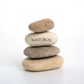 Stack of rocks labeled \'Natural\' isolated on white background Royalty Free Stock Photo