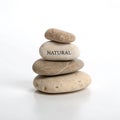 Stack of rocks labeled \'Natural\' isolated on white background Royalty Free Stock Photo