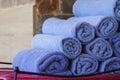 Stack roll of bath blue towels on table at swimming pool