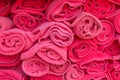 Stack roll of bath red towels on wooden table