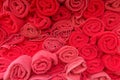 Stack roll of bath red towels on wooden table