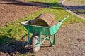 Stack of rolled grass sod for lawns and gardening in garden wheelbarrow Royalty Free Stock Photo