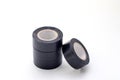 Stack of rolls black vinyl insulating tape on the white background