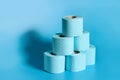 A stack of rolls of toilet paper on a blue background with copy space Royalty Free Stock Photo