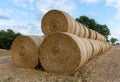 Stack of round bales of straw on a stubble field Royalty Free Stock Photo