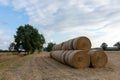 Stack of round bales of straw on a stubble field Royalty Free Stock Photo