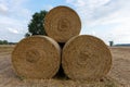 Stack of round bales of straw on a stubble field Royalty Free Stock Photo